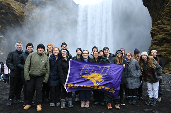 UNI Students infront of iceland waterfall